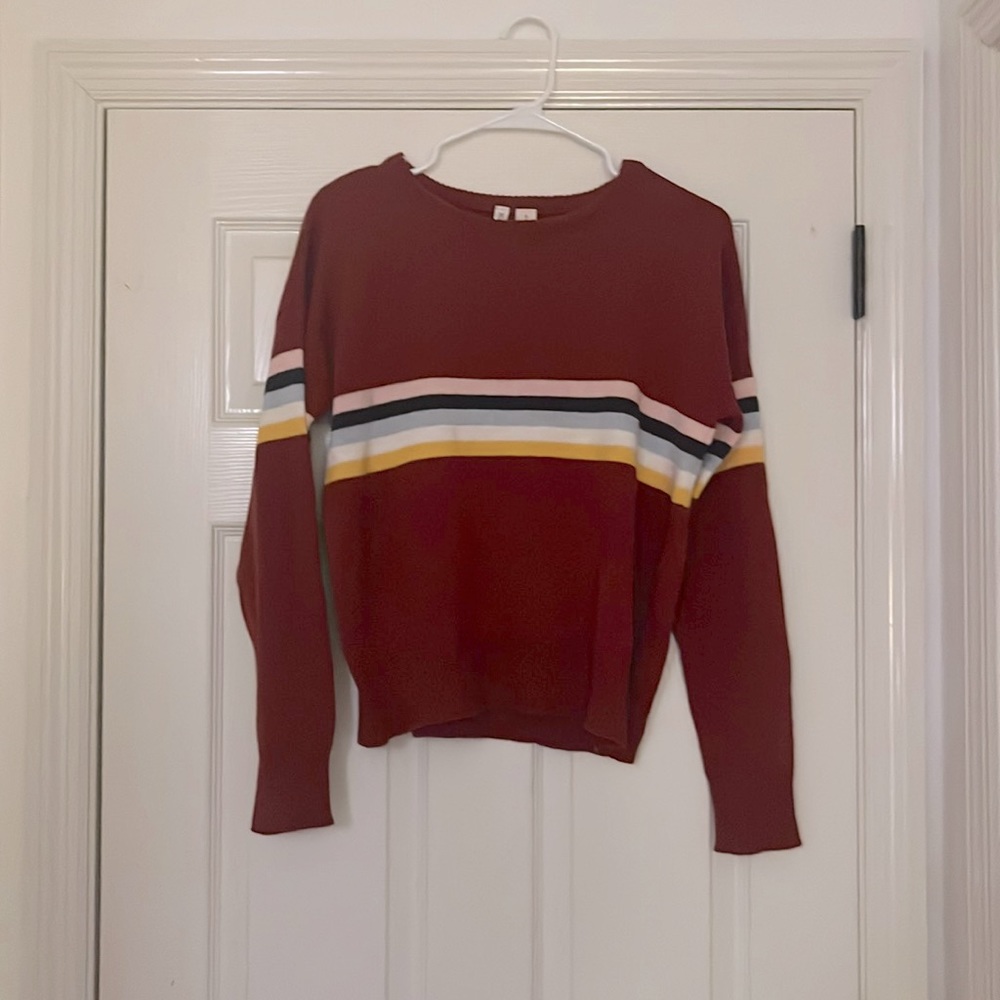 Cute Red Sweater with singular colorful stripes across the chest.